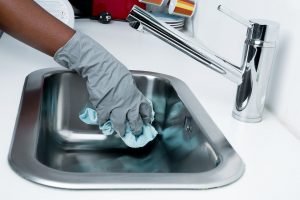 Person cleaning the kitchen sink