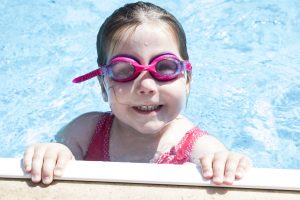girl in the pool, smiling