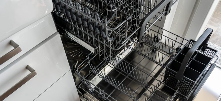 Opne dishwasher with visible racks, trays, and baskets