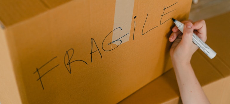 Person labeling a box